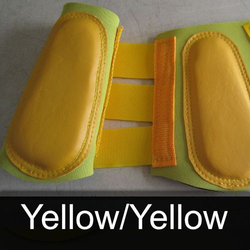 A pair of yellow and green boots with the words yellow / yellow below them
