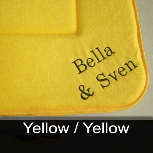 A yellow towel with bella and sven embroidered on it