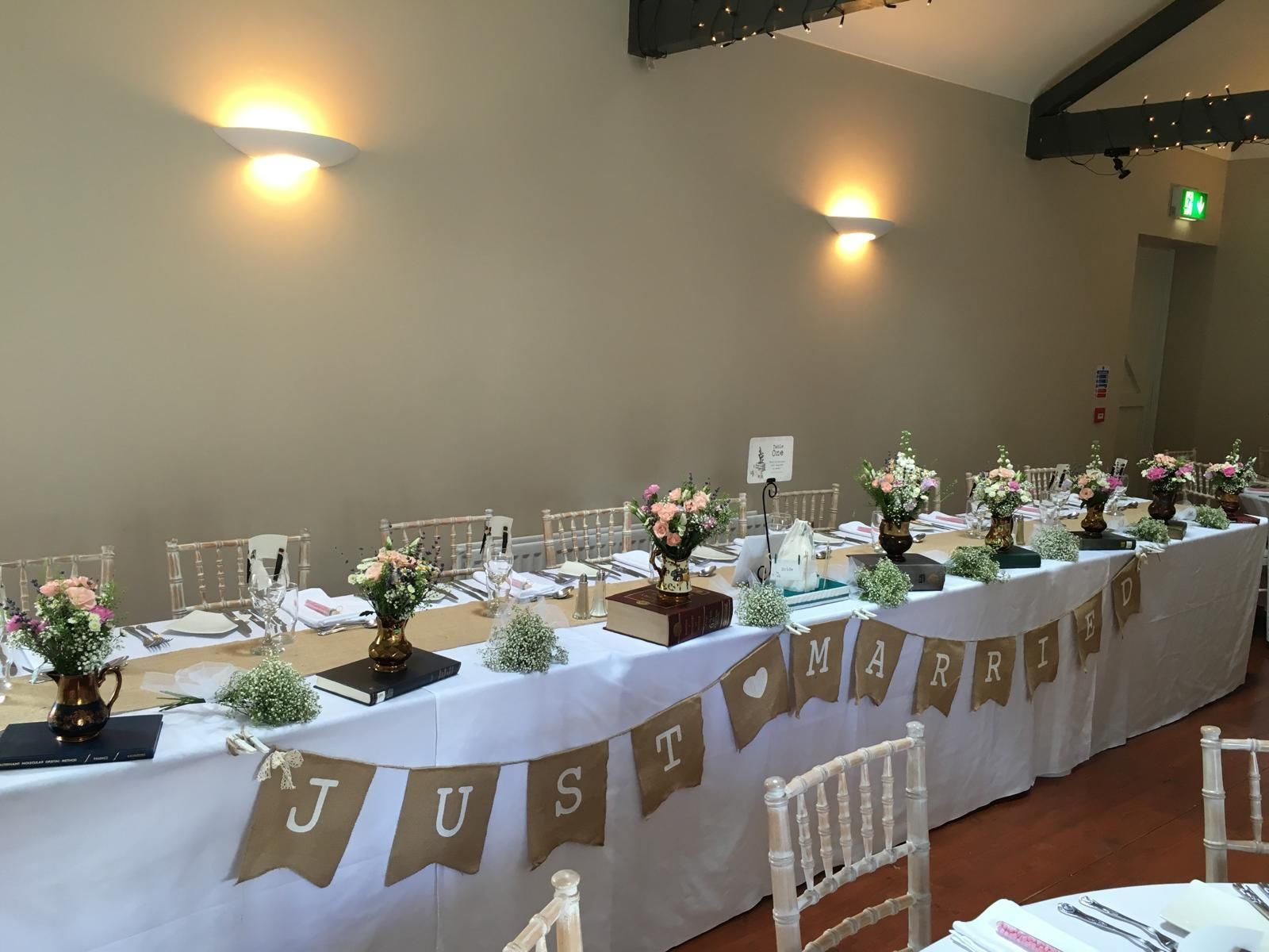 Wedding reception table set with floral centerpieces, 