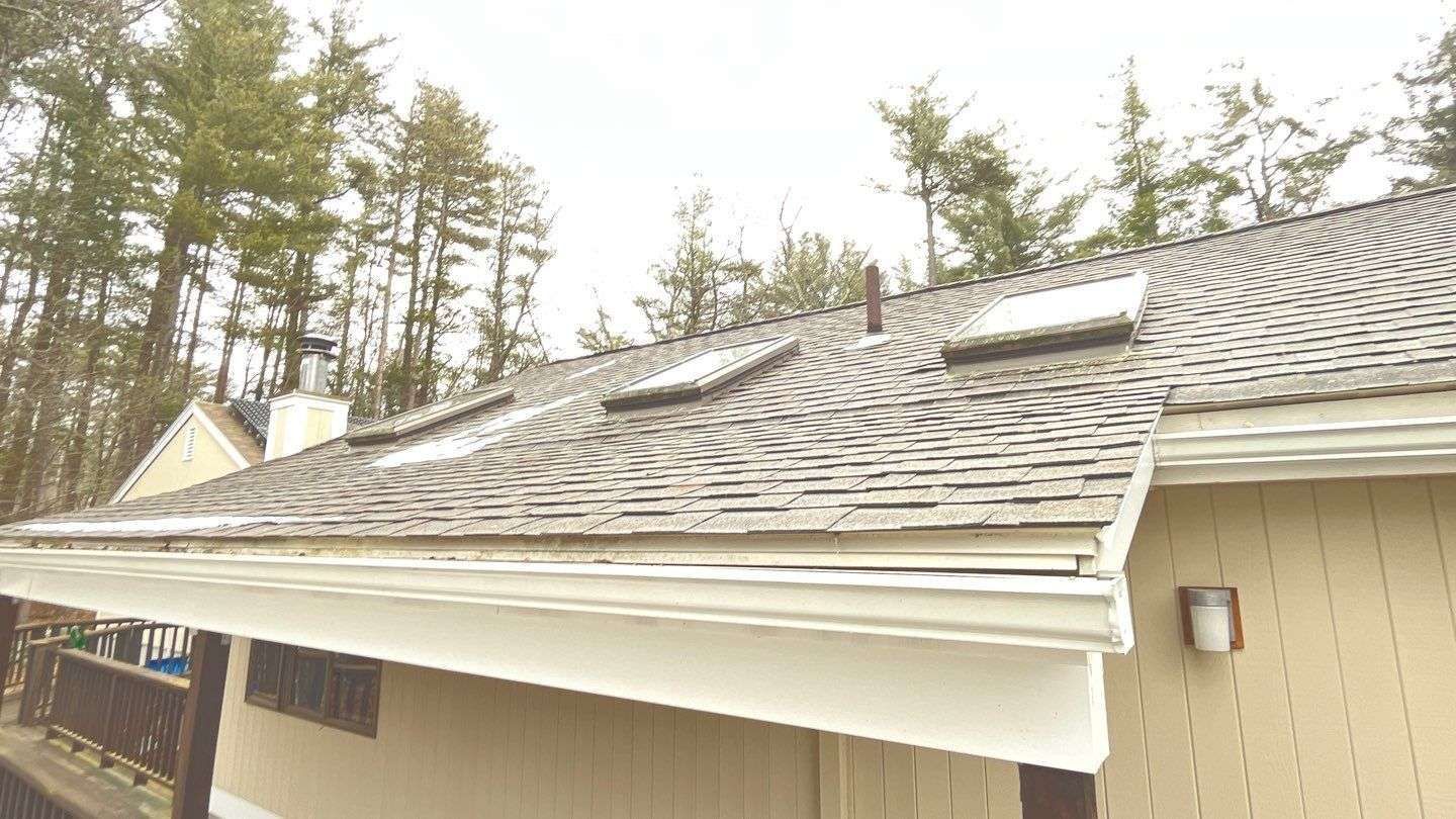 a house with a roof that has two skylights on it .