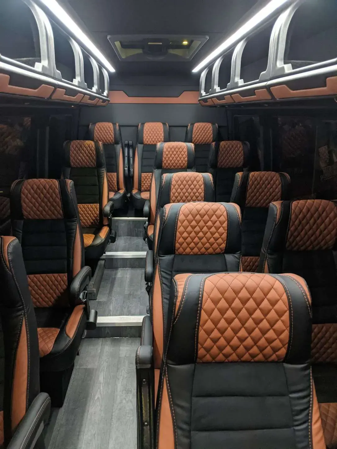 The inside of a bus with lots of seats and a table.