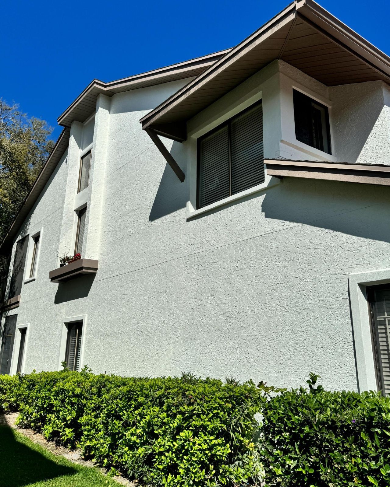 A large white house with a blue sky in the background