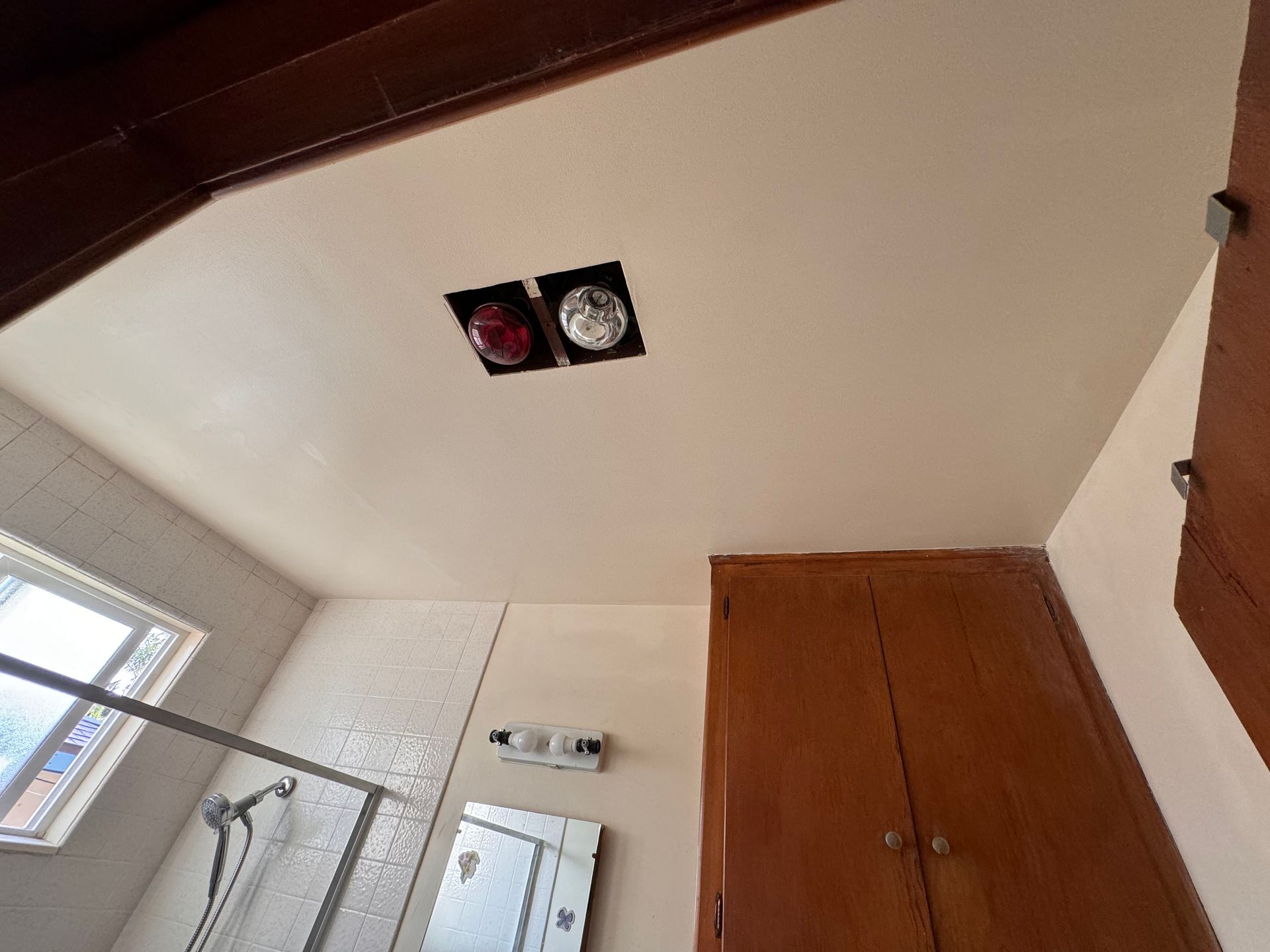 A bathroom with a clock on the ceiling