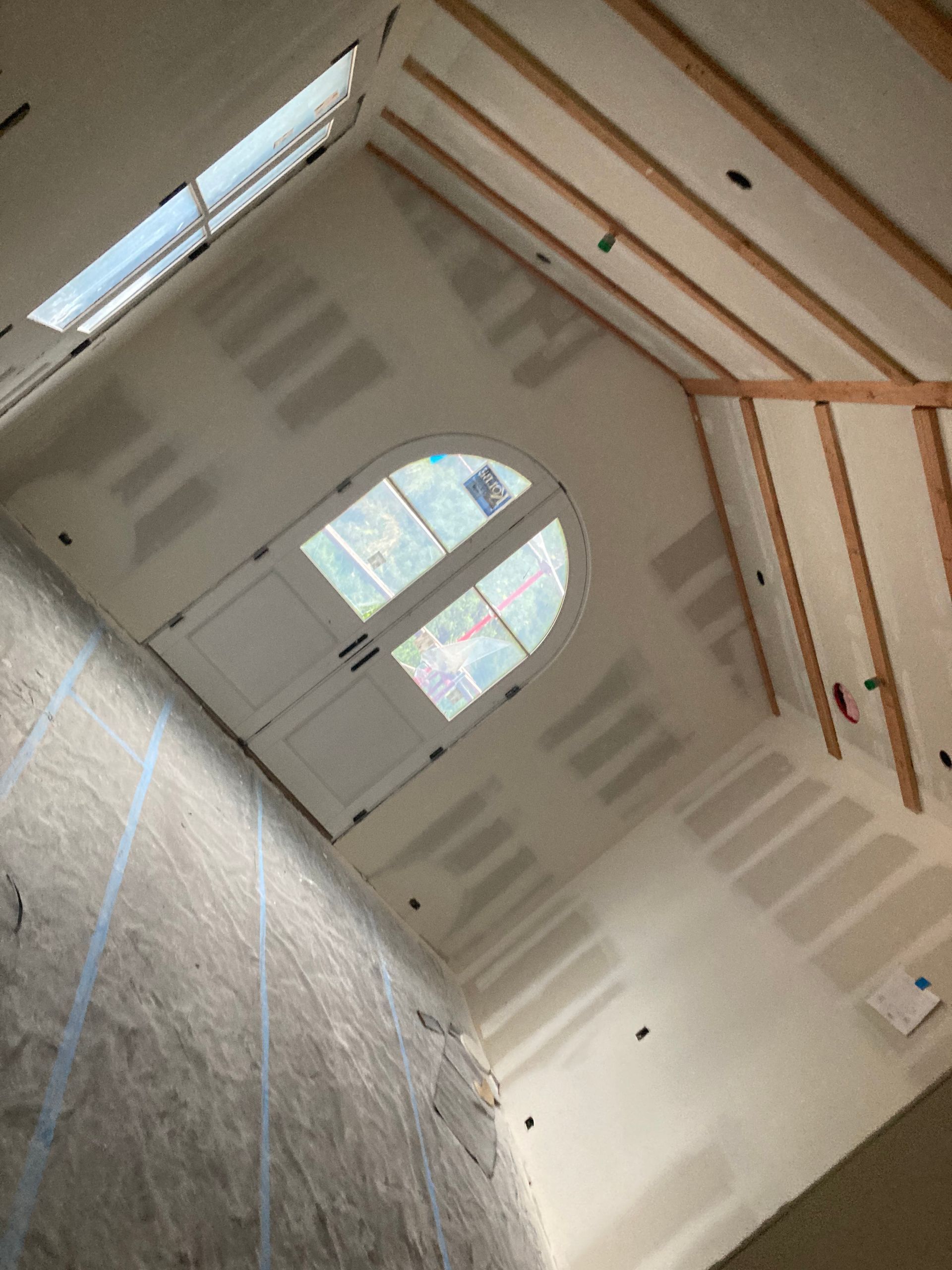 Looking up at the ceiling of a room with a window