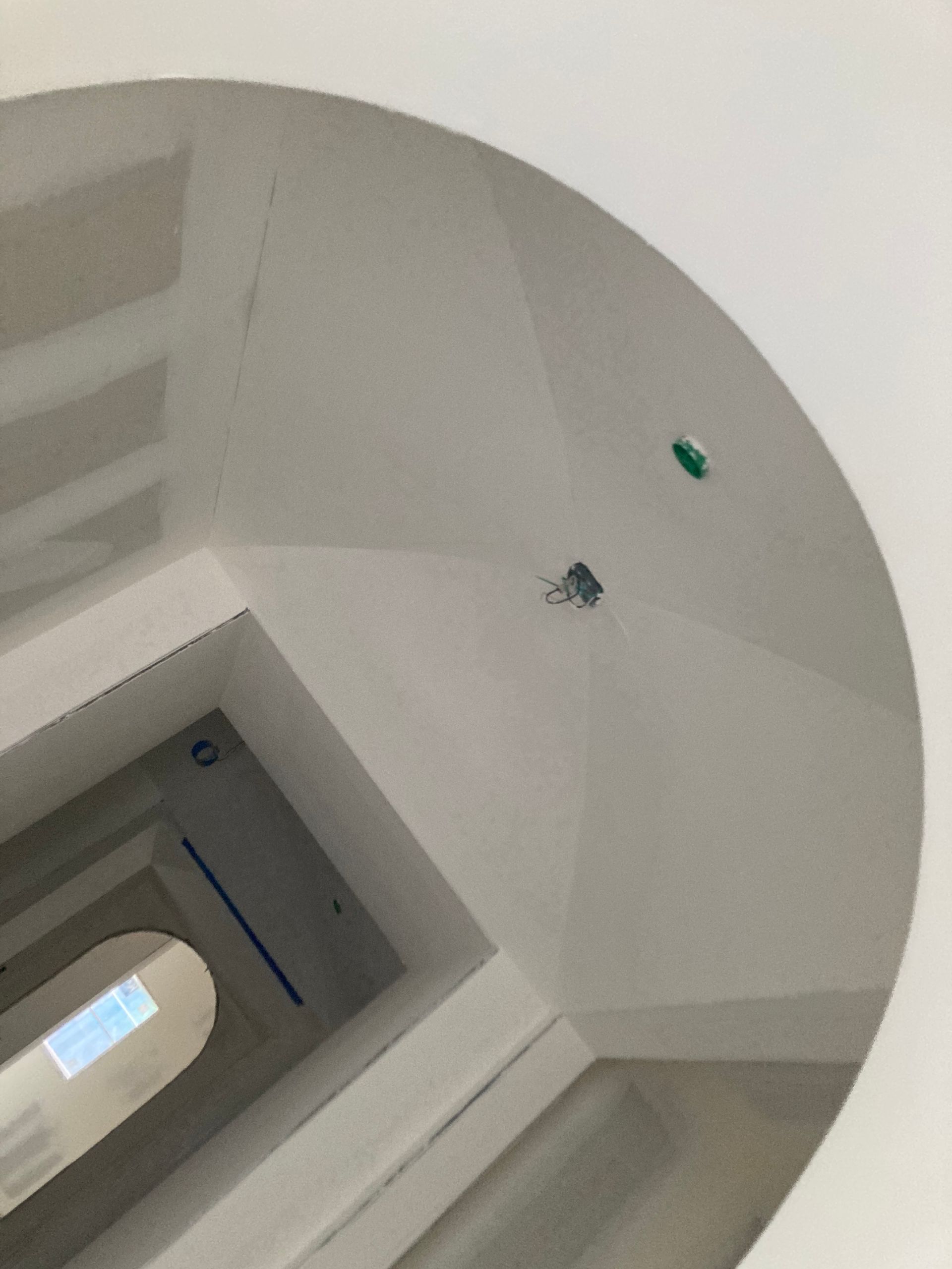 A round mirror with a hole in the middle of it