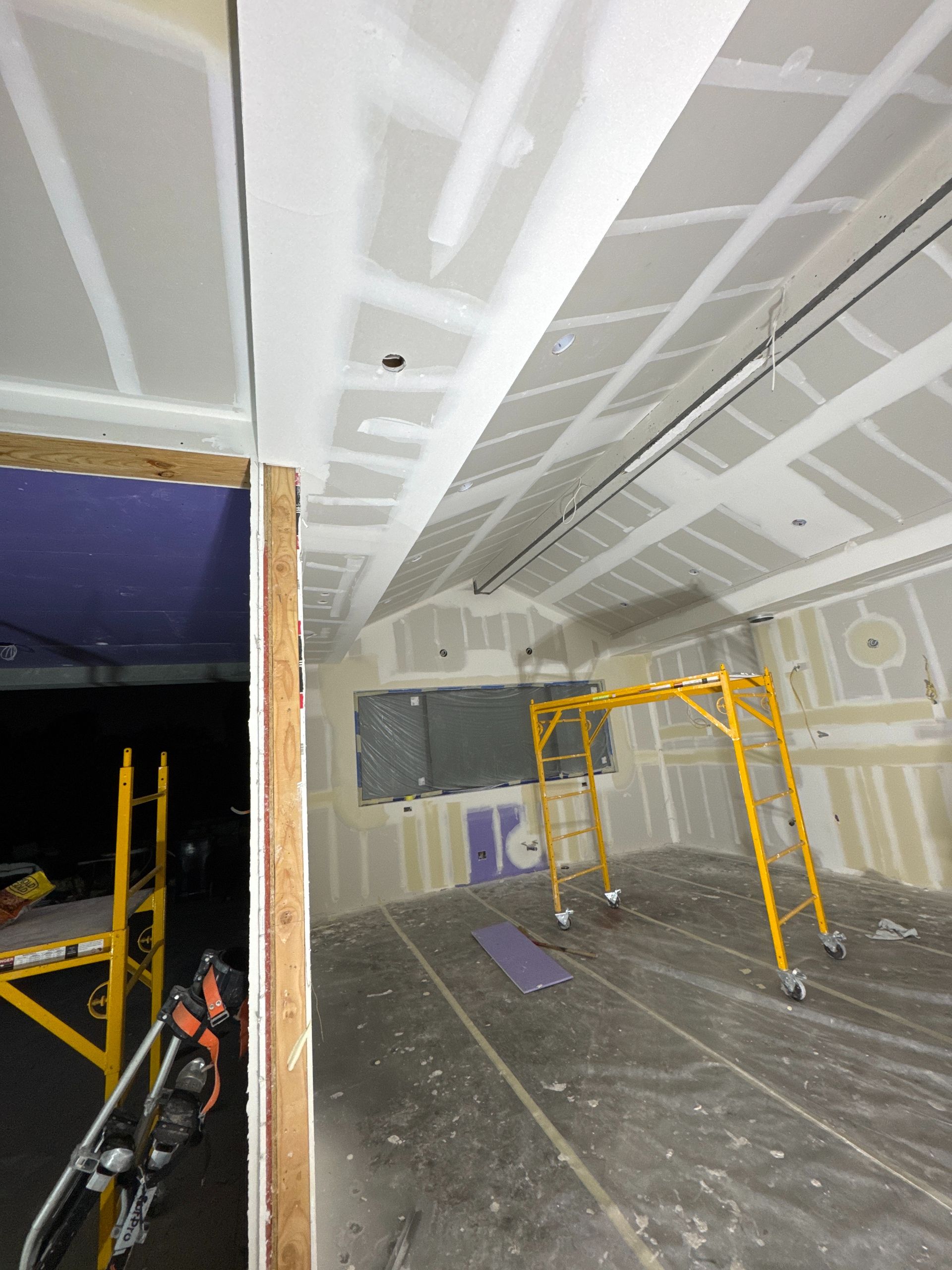 A room with a ladder and a scaffolding in it