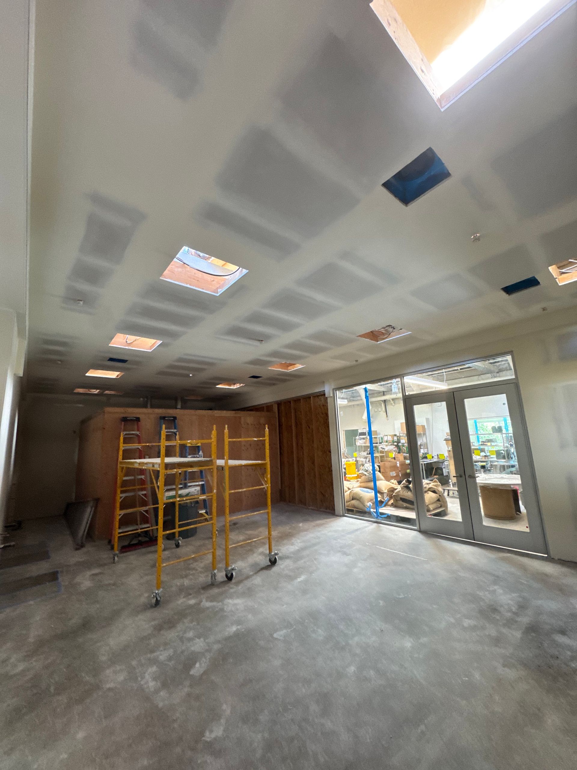 A large room with a ceiling that is being remodeled