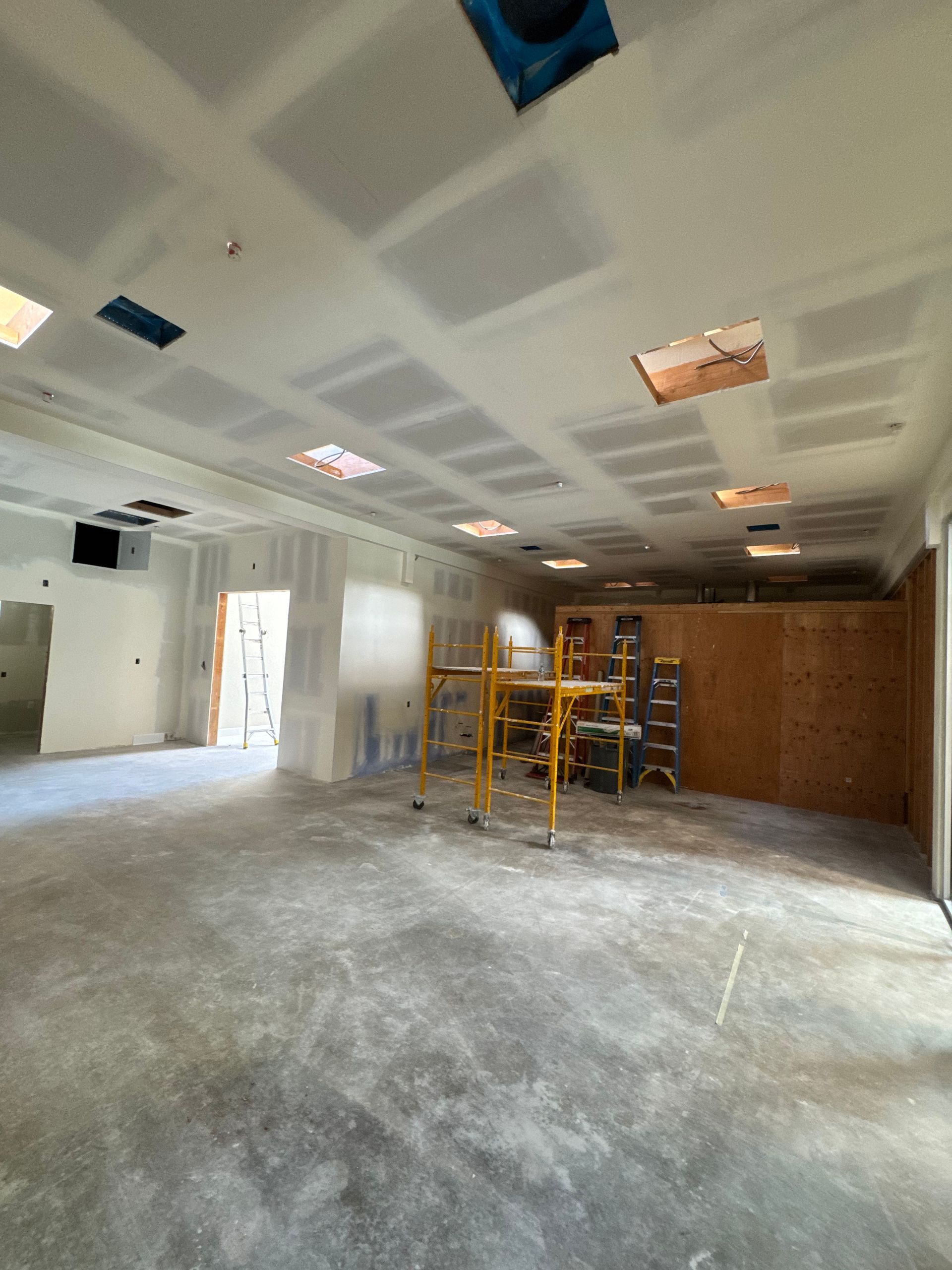 A large empty room with a scaffolding in the middle of it.