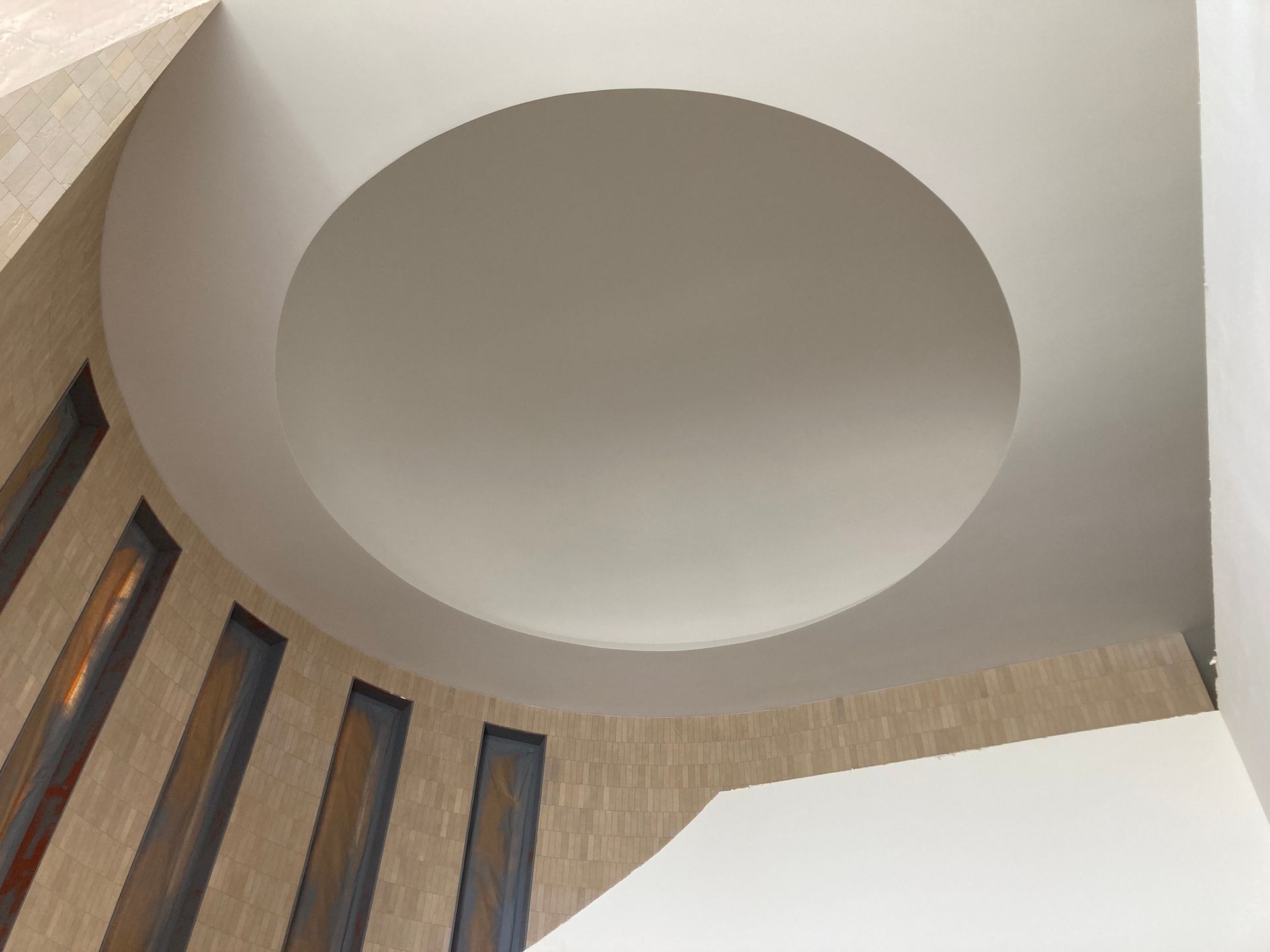 Looking up at a circular ceiling in a building
