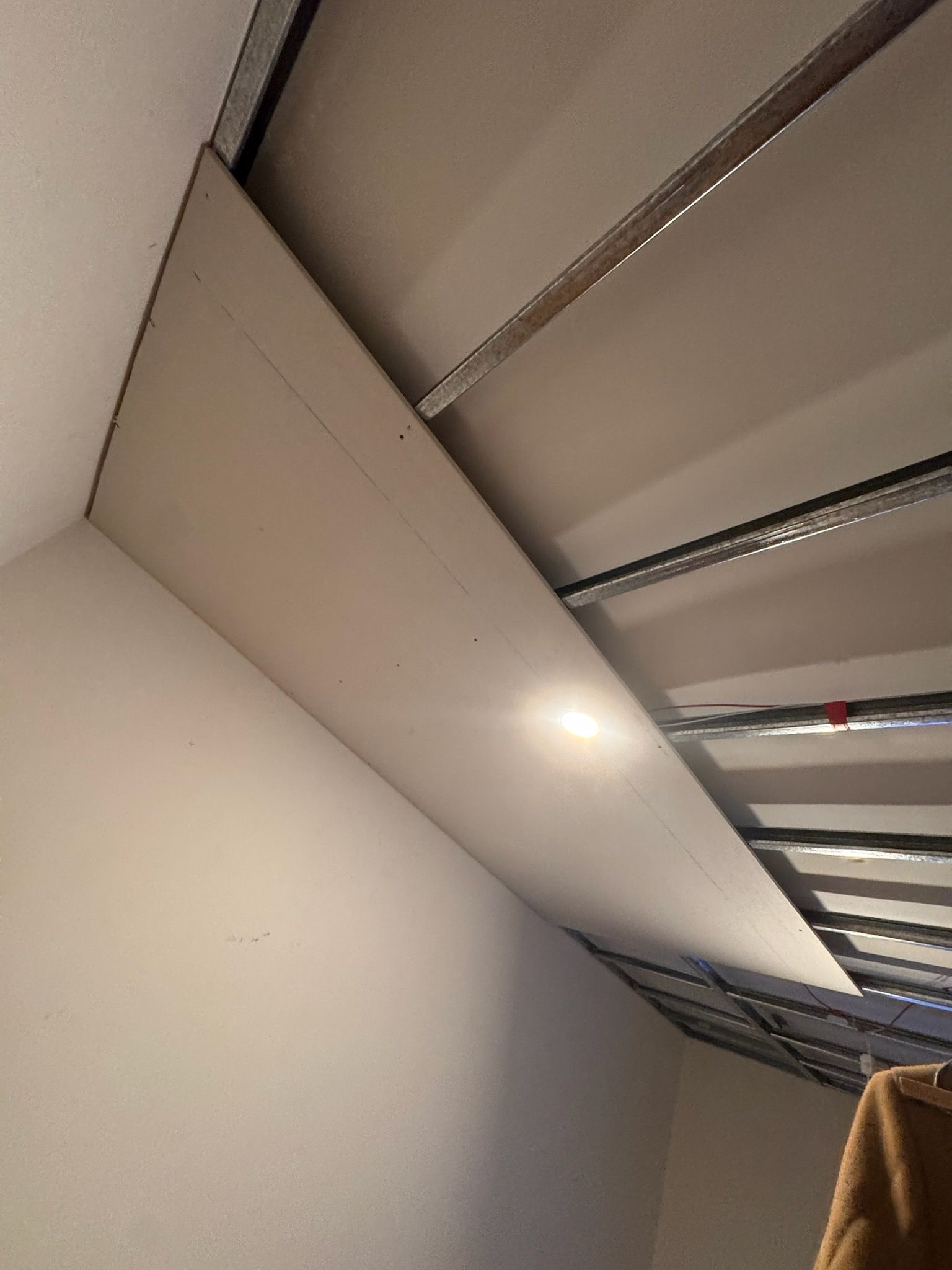 A bedroom with a ceiling that is being built.