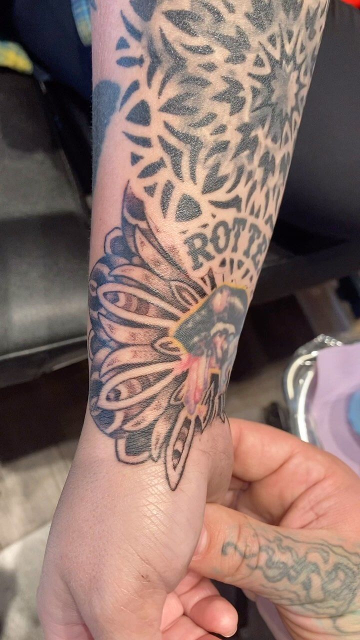 A close up of a person 's arm with a tattoo on it