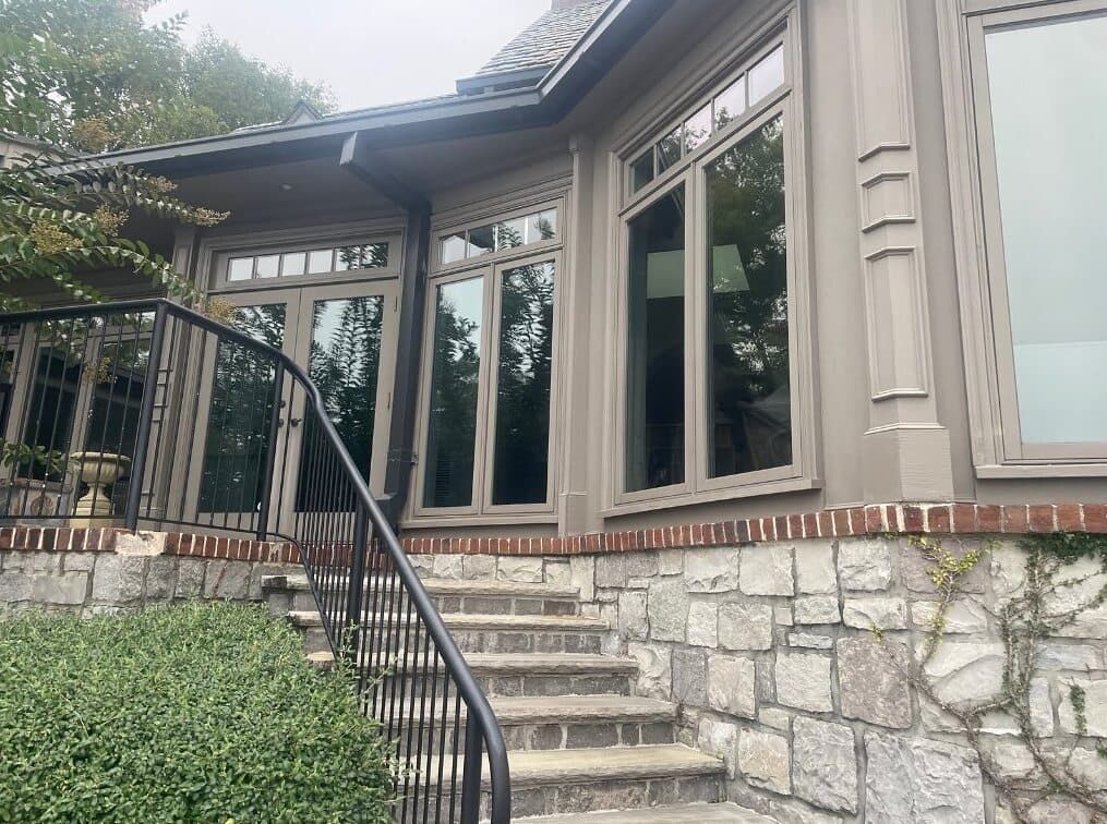 A house with stairs leading up to it and a railing.