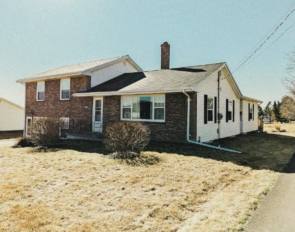 A brick house with a chimney on the roof