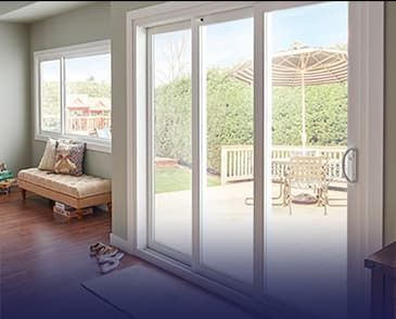 A living room with sliding glass doors leading to a patio.