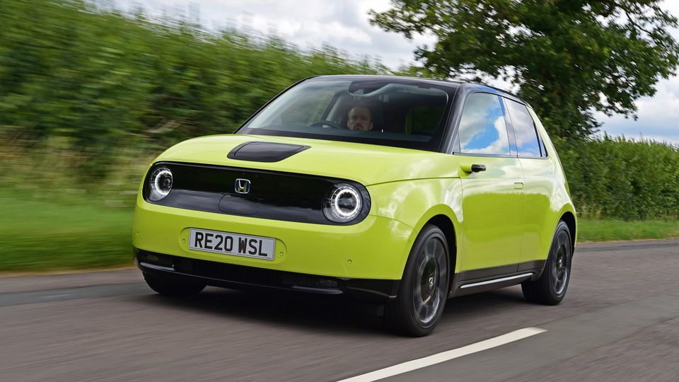 yellow electric honda car travels down UK country lane