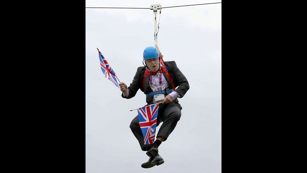 borris johnson looking like a fool hanging with flags in his hands
