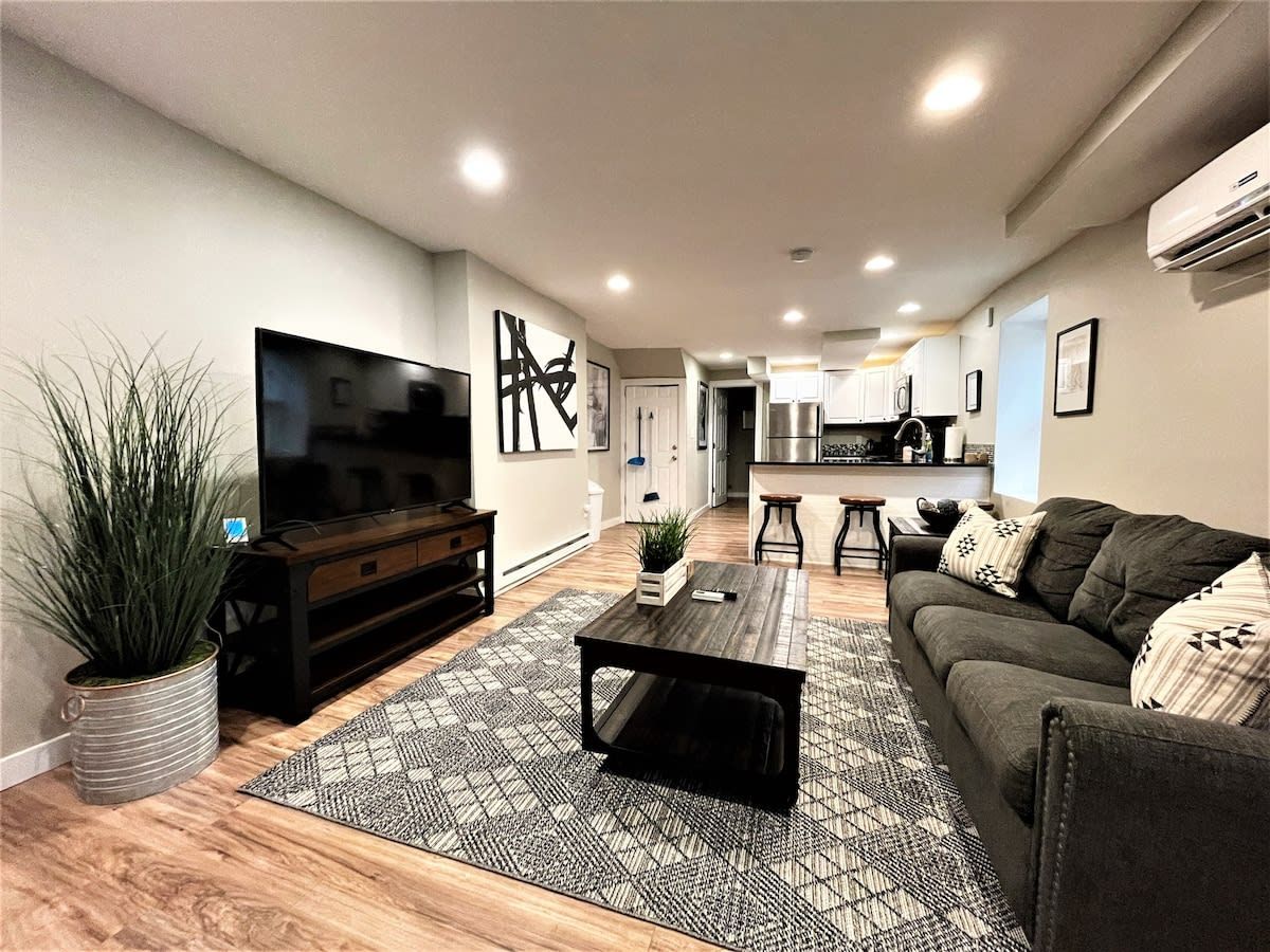 A living room with a couch , coffee table , and television.