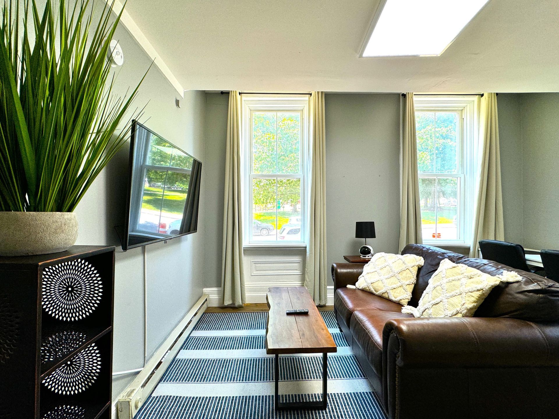 A living room with a couch , table , and refrigerator.