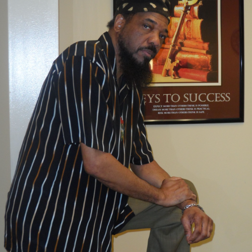 Microphone on stand, blurred crowd in background.