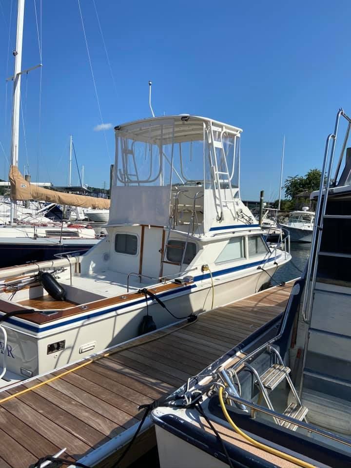 a boat is docked at a marina on a sunny day .
