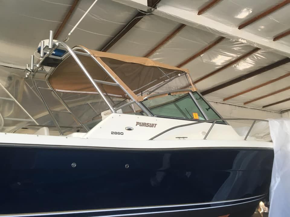 a boat with a canopy on top of it in a warehouse