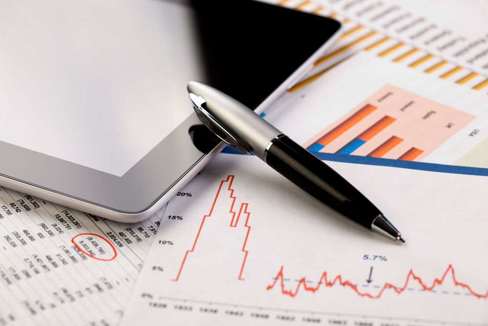 A Pen Is Sitting On A Piece Of Paper With A Graph On It — Mid Coast Mowers In Taree, NSW