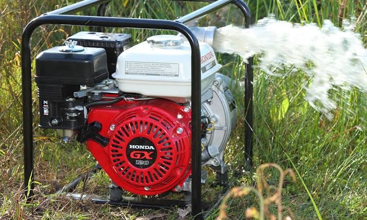 A Red and White Honda Gx Engine Is Being Used to Pump Water — Mid Coast Mowers In Taree, NSW