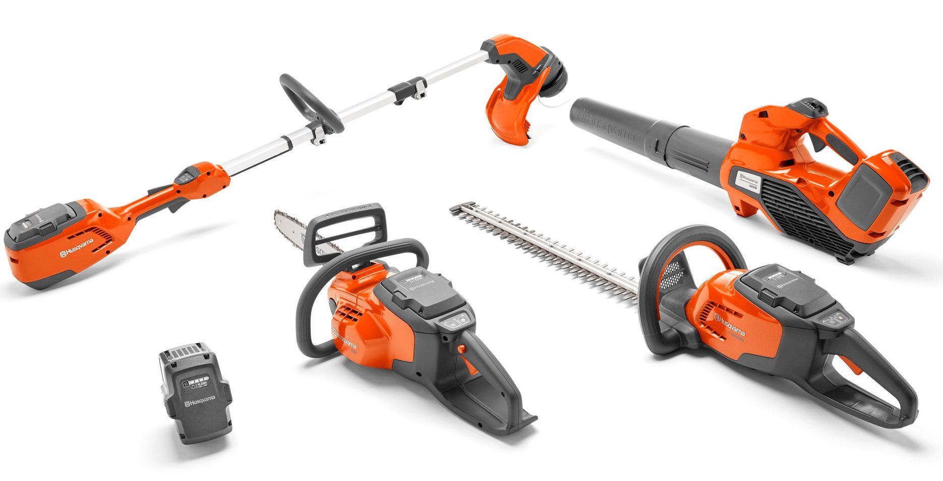 A Group of Lawn and Garden Tools Are Sitting on Top of Each Other on A White Surface — Mid Coast Mowers In Taree, NSW