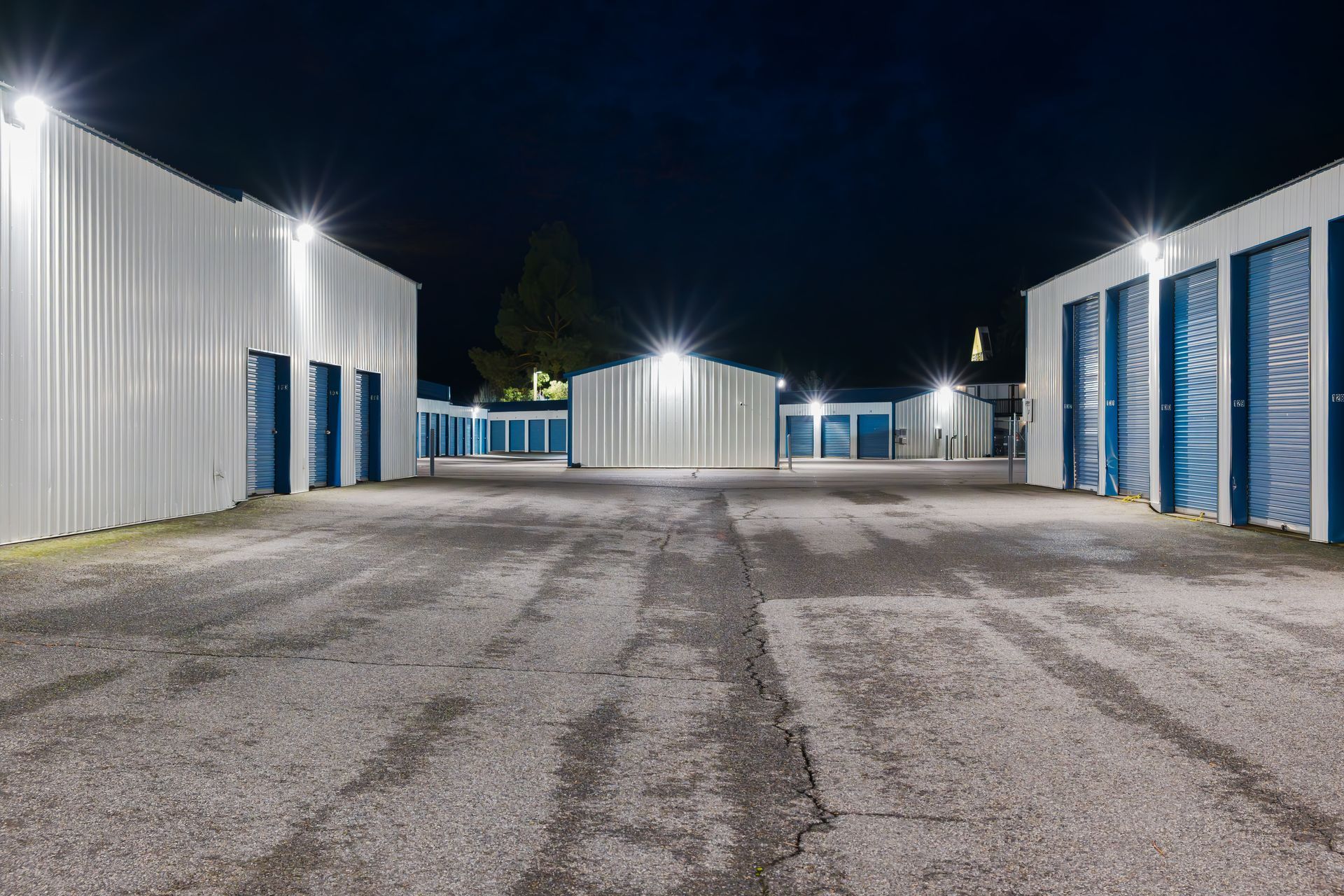 Evening view of a large illuminated self-storage facility. Evening view of a large illuminated self-storage facility.