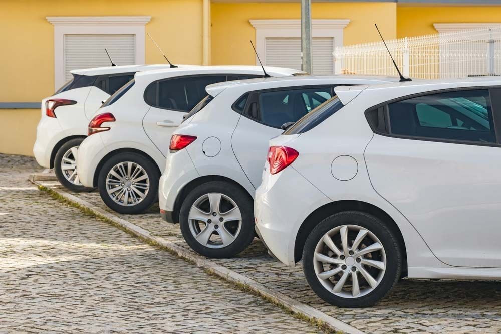 A Row of White Cars Are Parked in a Parking Lot — Dave's Used Cars In Stuart, NT