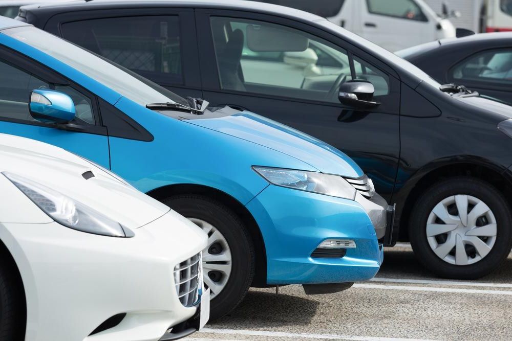 A Row of Cars Are Parked Next to Each Other in a Parking Lot — Dave's Used Cars In Stuart, NT