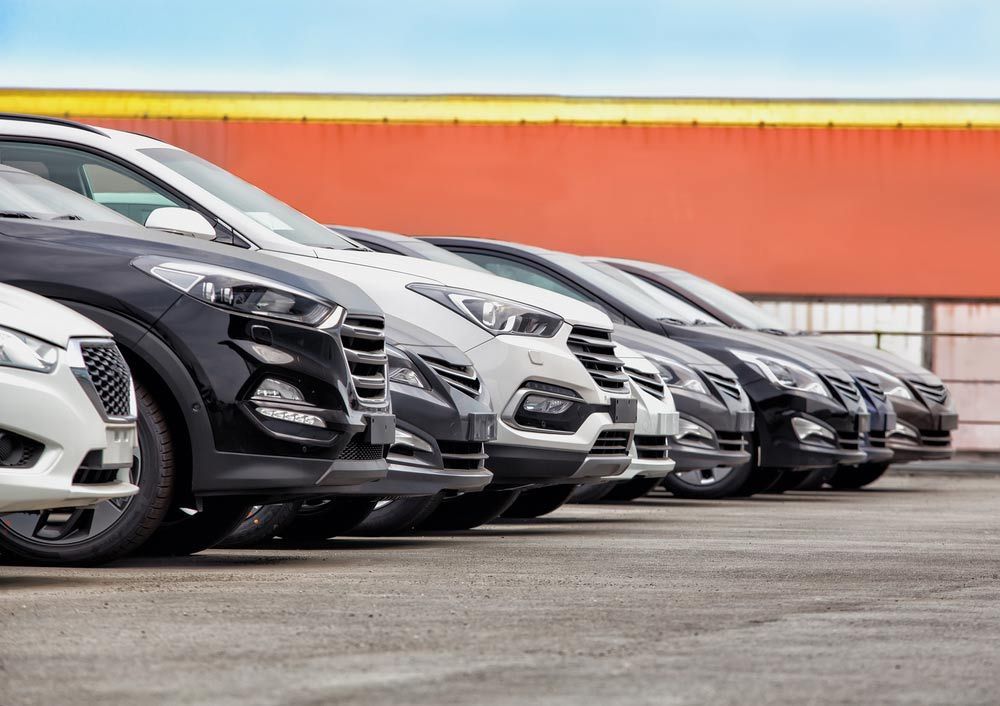 A Row of Cars Are Parked Next to Each Other in a Parking Lot — Dave's Used Cars In Stuart, NT