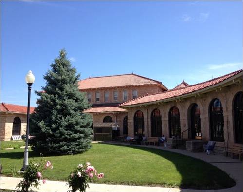 A large building with a red tile roof and arched windows