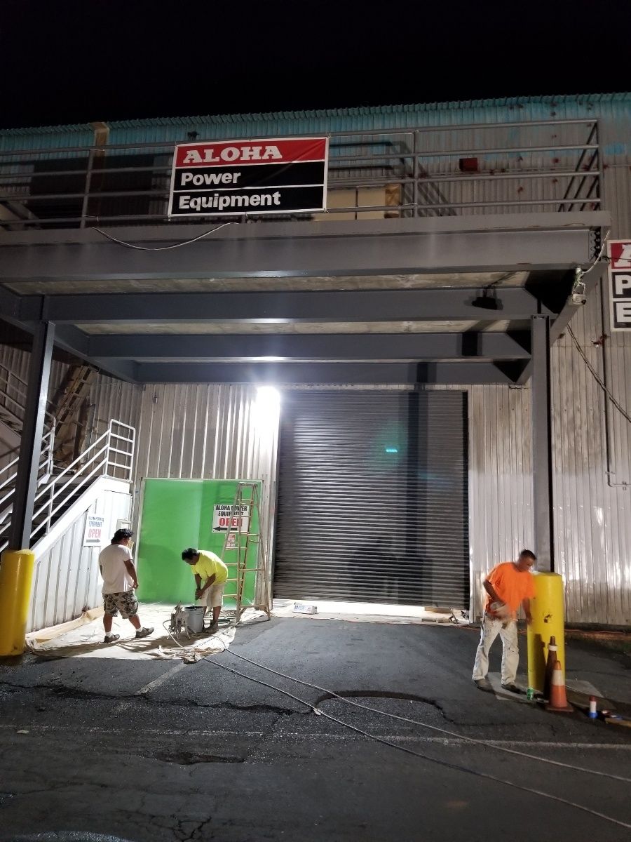 A group of people are working on a building at night.