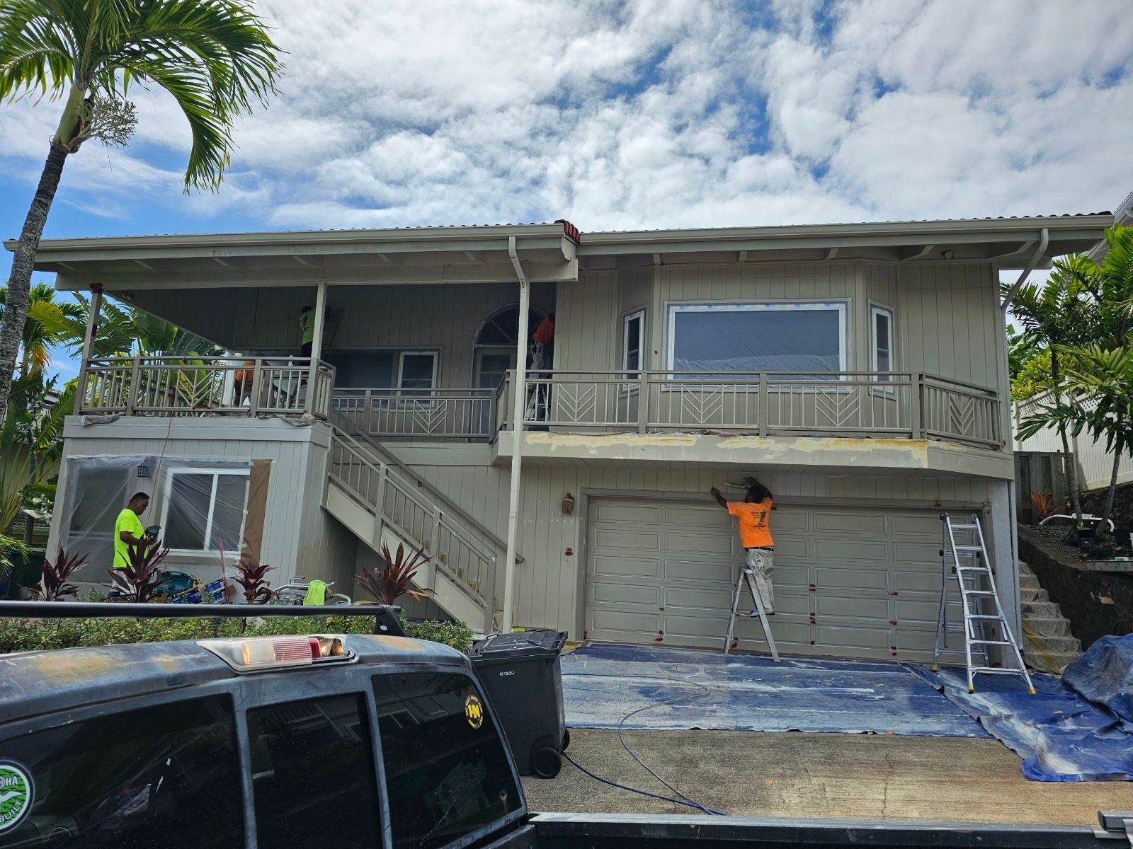 A man is painting the side of a house.
