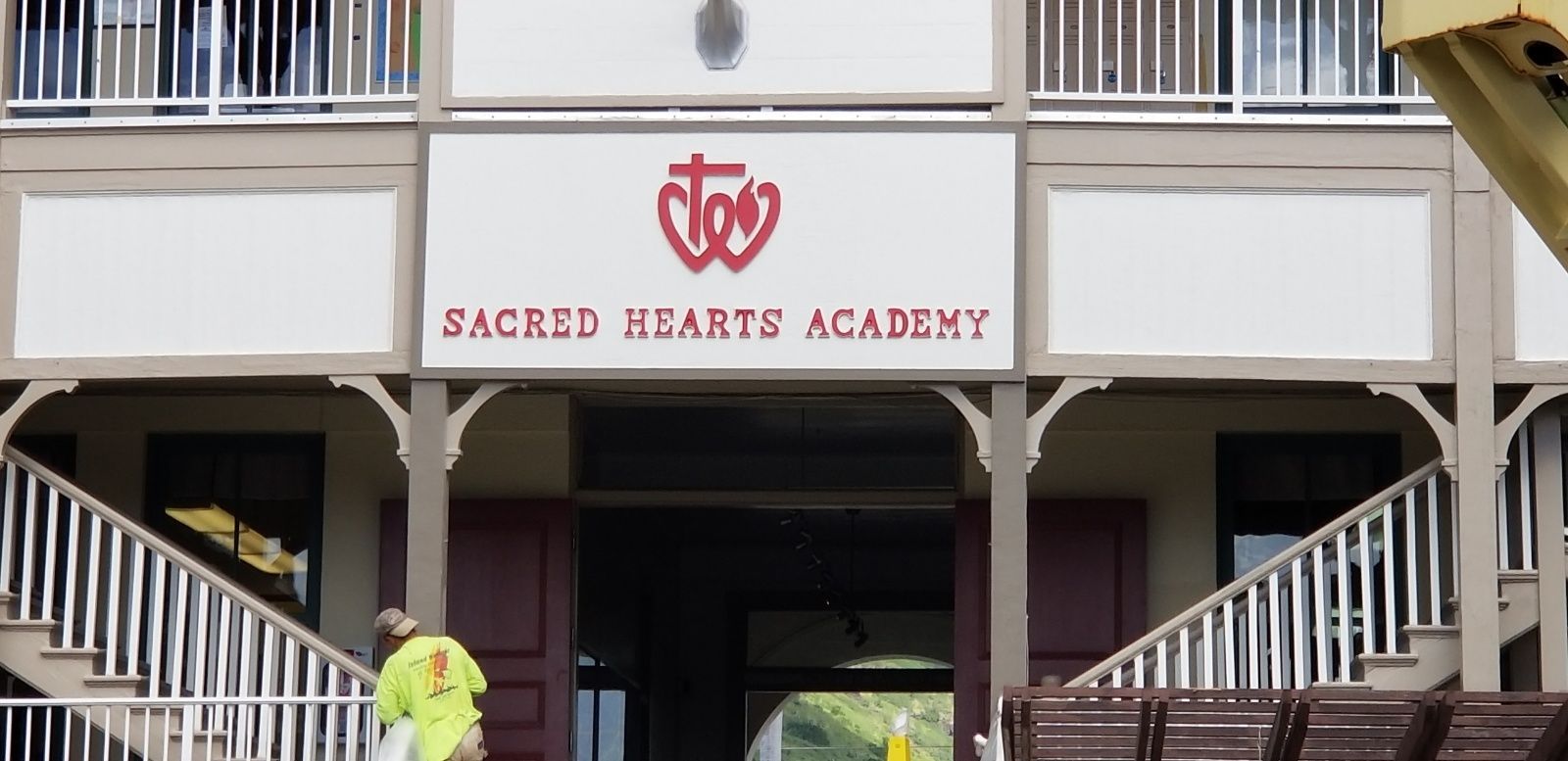 A building with a sign that says sacred hearts academy