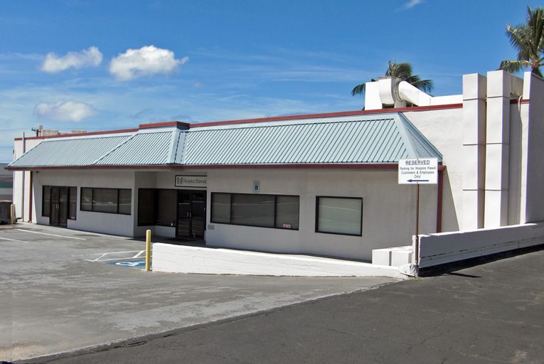 A white building with a sign that says no parking