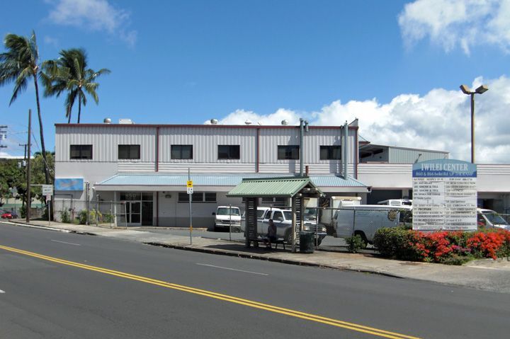 A large building with a bus stop in front of it