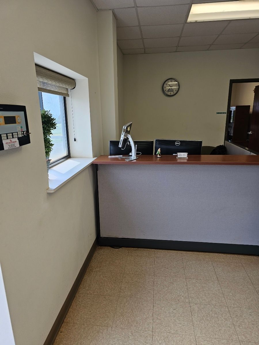 There is a clock on the wall above the reception desk.
