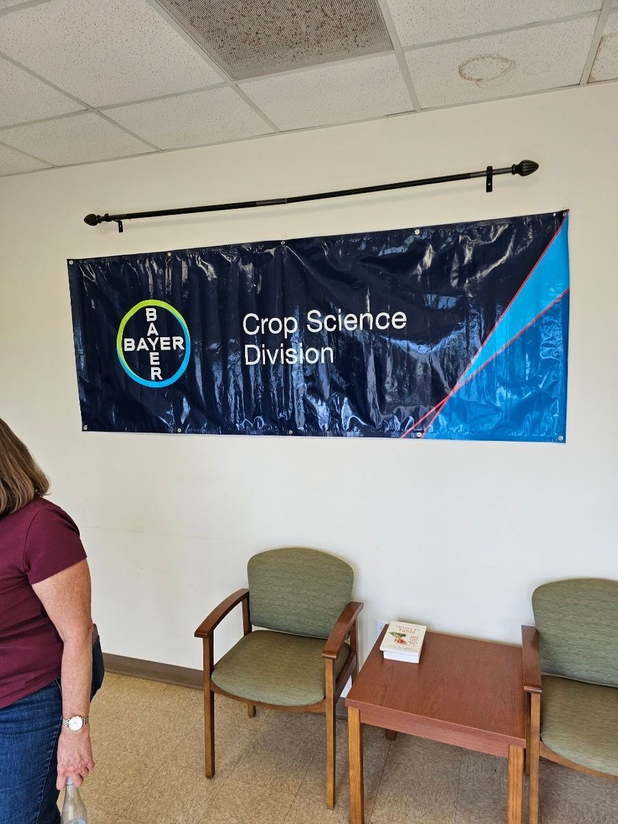 A woman is standing in front of a sign that says crop science division