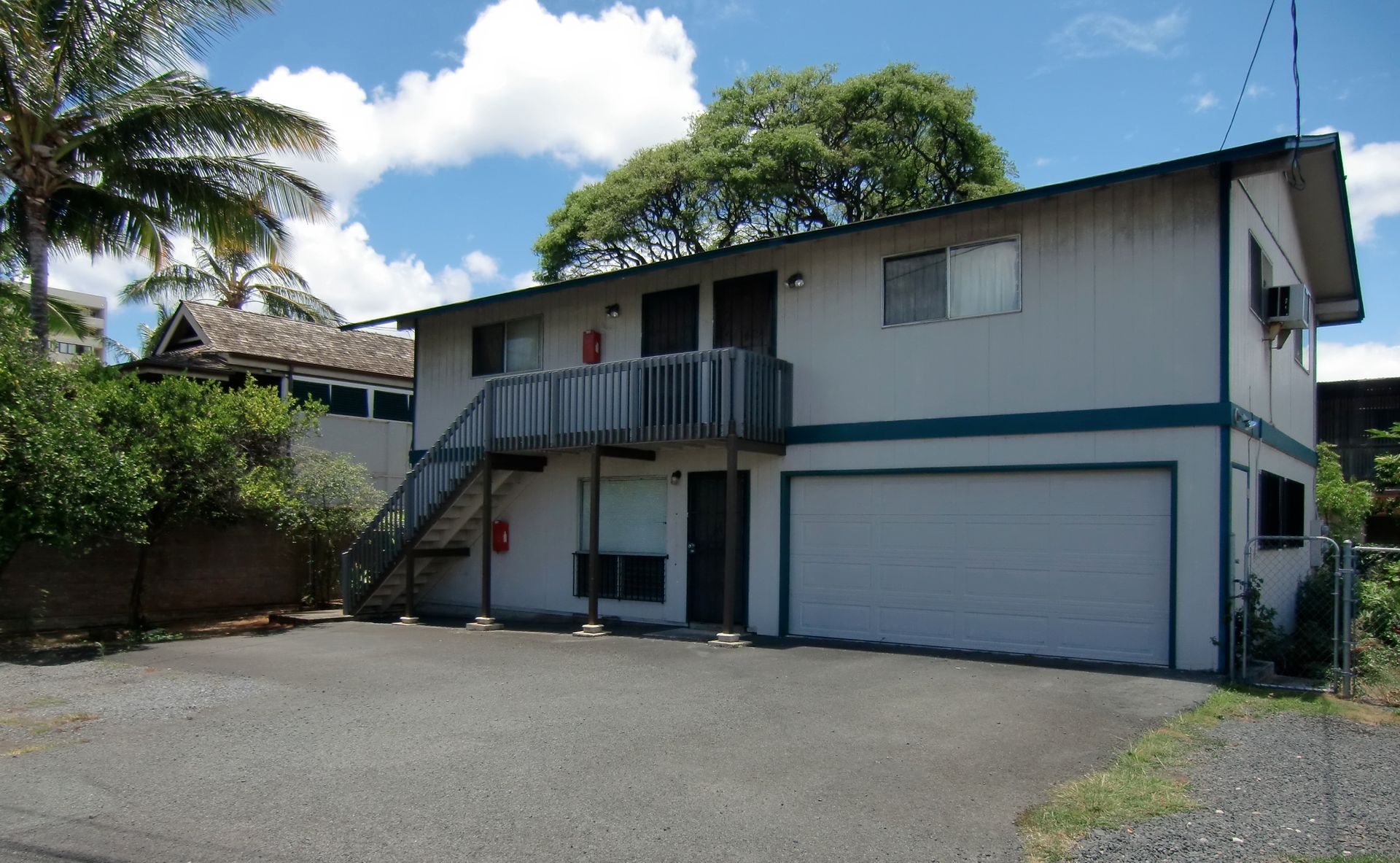 A white house with a garage and stairs