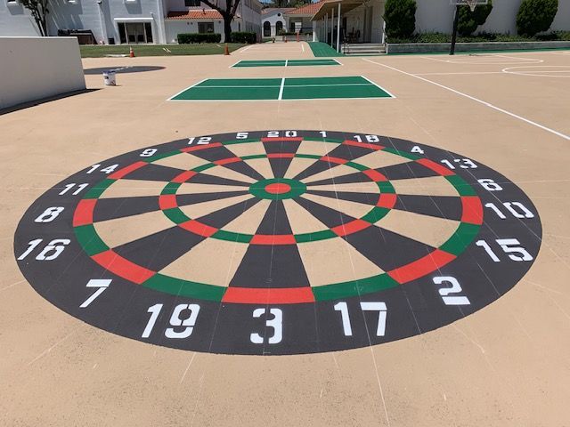 A dart board is painted on a concrete surface