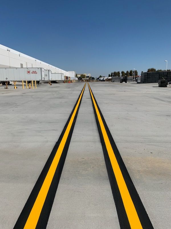 A yellow line is painted on the floor of a building