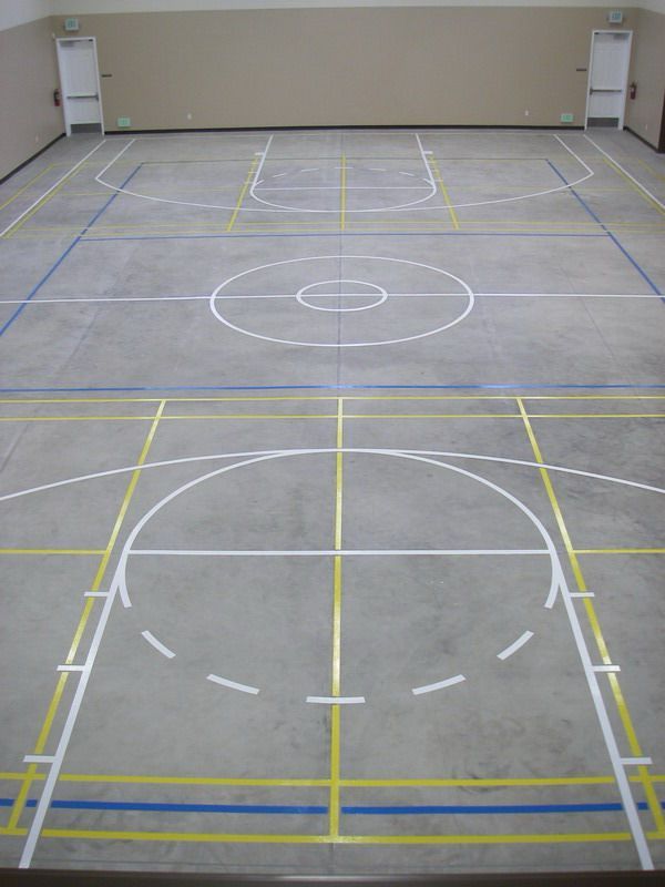 A basketball court with yellow lines on the floor