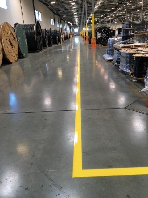 A warehouse with a yellow line on the floor