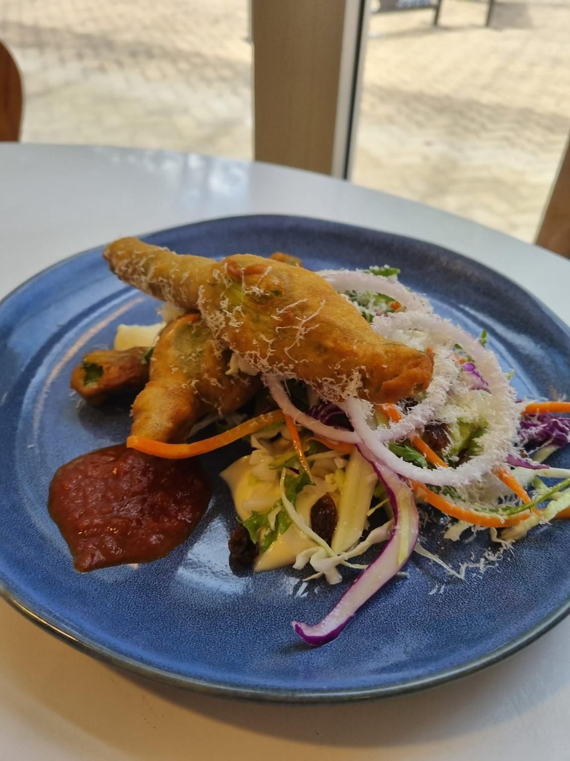 A Blue Plate Topped With Fried Food And Vegetables On A Table — Top Point Café In East Gosford, NSW