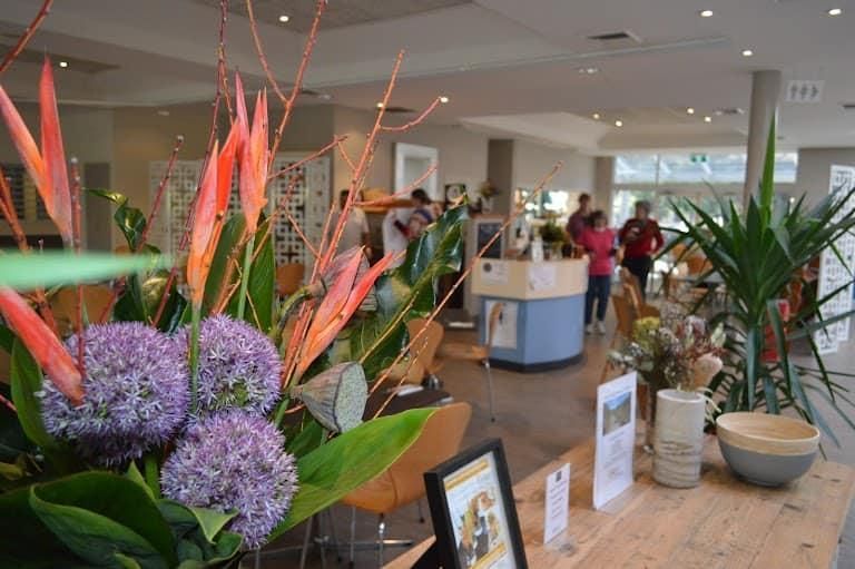 A Bunch Of Flowers Are Sitting On A Table In A Room — Top Point Café In East Gosford, NSW