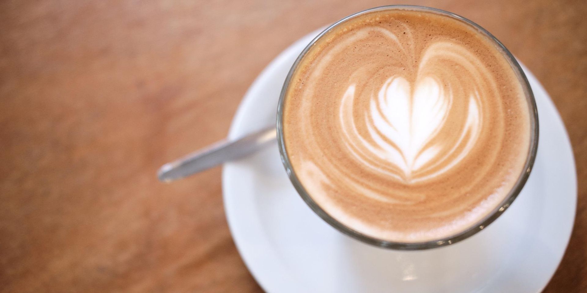 A Table With Plates Of Food And Wine Glasses On It — Top Point Café In East Gosford, NSW