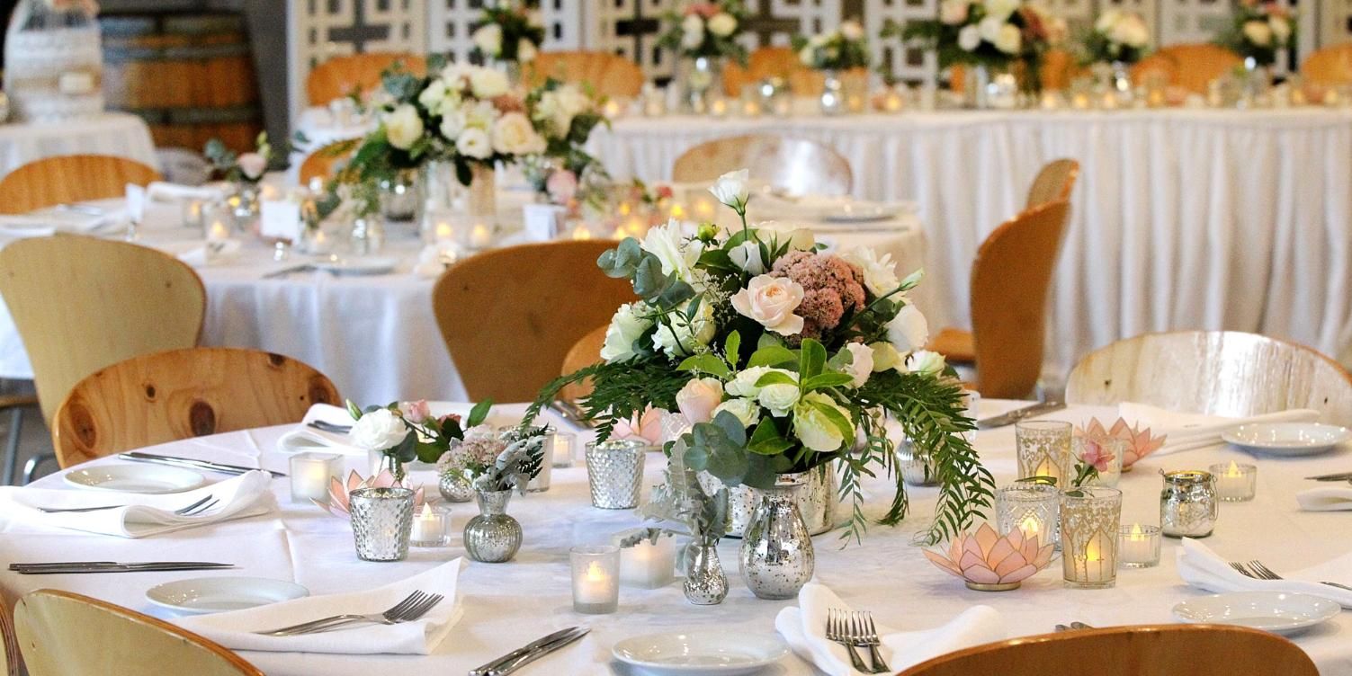 A Table Set For A Wedding Reception With Flowers And Candles On It — Top Point Café In East Gosford, NSW