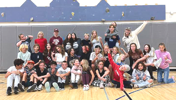 A group of children are sitting on a bus.